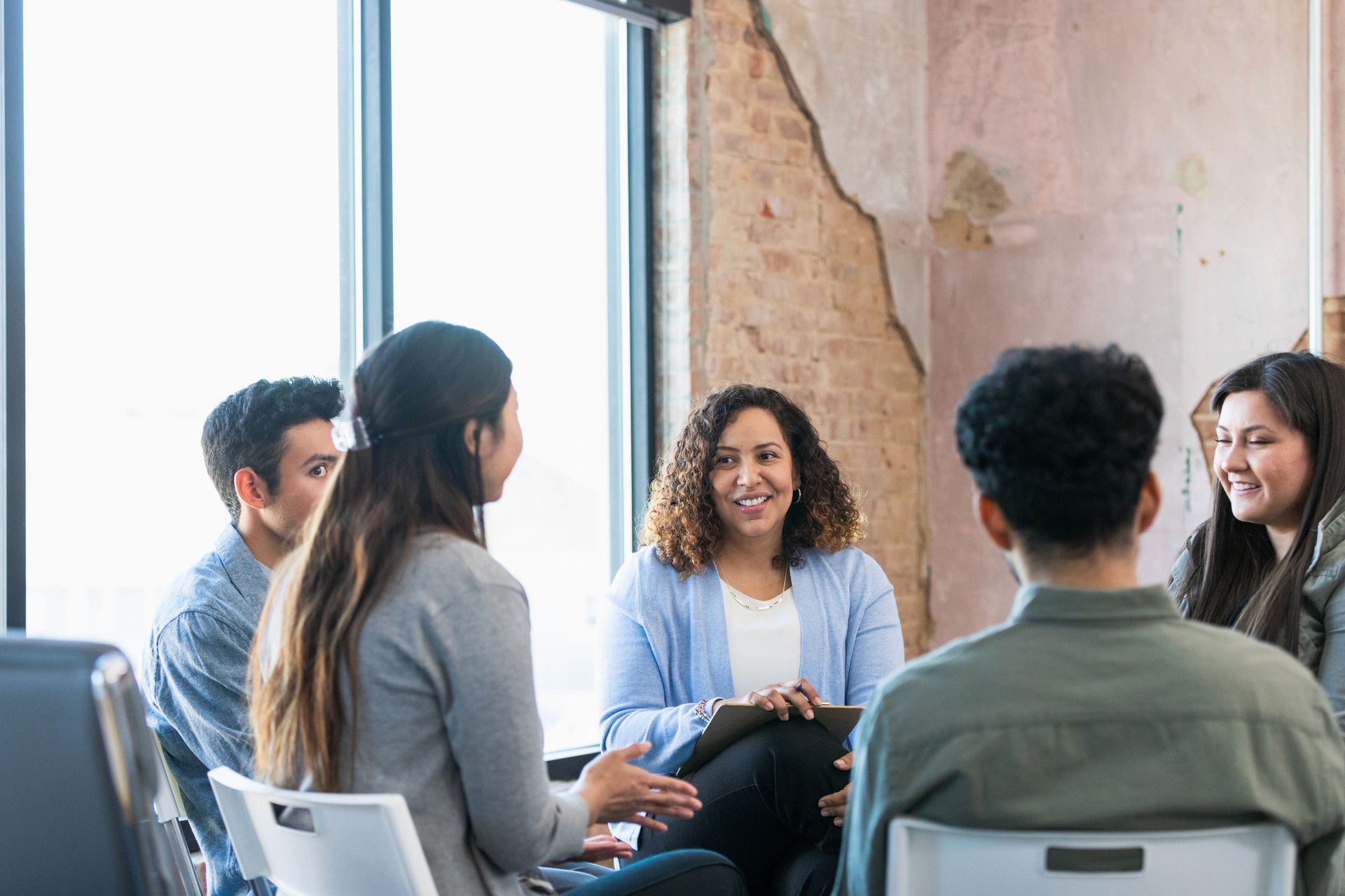 Diverse people gather for employee engagement meeting