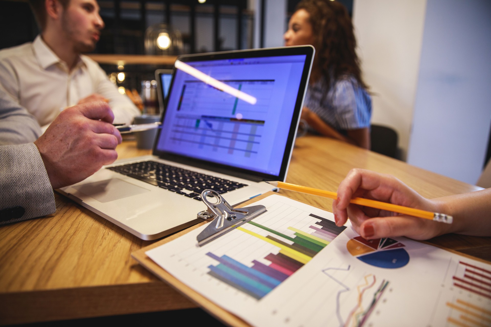 Professional business team working with laptop computer and graphs